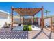 Backyard with custom wooden pergola and shaded area for golf and practice at 14616 N 28Th Pl, Phoenix, AZ 85032