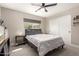 Cozy bedroom includes a large window, closet with sliding doors, and neutral carpeting at 14616 N 28Th Pl, Phoenix, AZ 85032