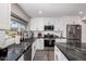 A stylish kitchen with stone countertops, white cabinets, and stainless steel appliances at 14616 N 28Th Pl, Phoenix, AZ 85032