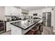 Bright kitchen boasts white cabinets, stainless steel appliances, and a large island with bar seating at 14616 N 28Th Pl, Phoenix, AZ 85032