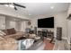Large living room with a modern TV and a comfortable sectional sofa, ideal for relaxing at 14616 N 28Th Pl, Phoenix, AZ 85032
