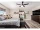 Comfortable main bedroom featuring wood-look tile floors, floating shelves, and great natural light at 14616 N 28Th Pl, Phoenix, AZ 85032