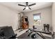 Bright workout room with exercise equipment and classic arcade game, illuminated by a modern ceiling fan at 14616 N 28Th Pl, Phoenix, AZ 85032