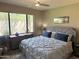 Comfortable bedroom featuring a plush bed, ceiling fan, and a large window that lets in plenty of natural light at 15252 N 100 St # 1146, Scottsdale, AZ 85260