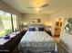 Comfortable bedroom featuring a plush bed, ceiling fan, and a large window that lets in plenty of natural light at 15252 N 100 St # 1146, Scottsdale, AZ 85260