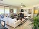 Well-lit living room features a fireplace, ceiling fan, and a sliding door to an outdoor seating area at 15252 N 100 St # 1146, Scottsdale, AZ 85260