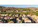Stunning aerial view of a residential area featuring homes with pools, golf course, and mountain backdrop at 16014 S 13Th Way, Phoenix, AZ 85048