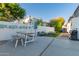 Inviting backyard features a dining table, seating area with a fire pit, and manicured landscaping at 16014 S 13Th Way, Phoenix, AZ 85048