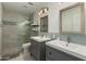 Elegant bathroom featuring dual sinks, a glass-enclosed shower with tile surround, and modern fixtures at 16014 S 13Th Way, Phoenix, AZ 85048