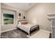 Cozy bedroom featuring a modern bed frame, stylish artwork, and a bright window view at 16014 S 13Th Way, Phoenix, AZ 85048