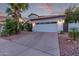 Well-maintained home exterior featuring a two-car garage, desert landscaping, and tile roof at 16014 S 13Th Way, Phoenix, AZ 85048