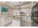 Bright kitchen features white cabinetry, granite countertops, a center island, and stainless steel appliances at 16014 S 13Th Way, Phoenix, AZ 85048