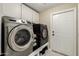 Well-organized laundry room with modern washer and dryer, ample storage, and a convenient layout at 16014 S 13Th Way, Phoenix, AZ 85048