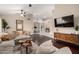 Spacious living area featuring hardwood flooring, a comfy sectional sofa, and stylish furnishings at 16014 S 13Th Way, Phoenix, AZ 85048
