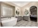 Luxurious main bathroom boasts double vanities, decorative tile floor, and soaking tub at 16014 S 13Th Way, Phoenix, AZ 85048