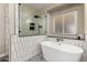 Elegant main bathroom boasts a stand alone tub, sleek shower, and decorative tile floors at 16014 S 13Th Way, Phoenix, AZ 85048