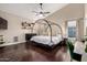 Spacious main bedroom boasts dark wood floors, a modern bed, and ample natural light at 16014 S 13Th Way, Phoenix, AZ 85048