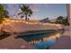 Private backyard pool featuring a tropical landscape, decorative lighting, and a comfortable lounging area at 16014 S 13Th Way, Phoenix, AZ 85048