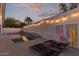 Backyard pool area with lounge chairs, string lights, and privacy walls for relaxation and enjoyment at 16014 S 13Th Way, Phoenix, AZ 85048