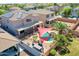 Aerial view of a serene backyard featuring a pool, rock waterfall, and outdoor seating area at 16322 N 171St Dr, Surprise, AZ 85388