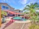 Backyard featuring a custom pool with rock waterfall, lush landscaping, and spacious patio at 16322 N 171St Dr, Surprise, AZ 85388