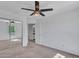 Spacious bedroom featuring carpet, a ceiling fan, and a mirrored closet for ample storage at 16322 N 171St Dr, Surprise, AZ 85388