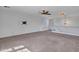 The bonus room features neutral colored walls, ceiling fan, carpet flooring and a lovely banister at 16322 N 171St Dr, Surprise, AZ 85388