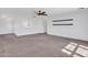 The bonus room boasts a ceiling fan and light fixture, neutral colored walls, carpet flooring and a banister at 16322 N 171St Dr, Surprise, AZ 85388
