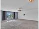 This bonus room features a ceiling fan, neutral walls, and a window providing plenty of natural light at 16322 N 171St Dr, Surprise, AZ 85388
