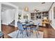 An open-concept dining area features a table with seating for four, with hardwood floors, and built-in shelving at 16322 N 171St Dr, Surprise, AZ 85388