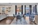 A breakfast nook features seating for four, dark wood floors, and natural light from the surrounding windows at 16322 N 171St Dr, Surprise, AZ 85388