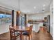 Cozy dining area featuring dark wood floors, modern lighting, and ample natural light from the sliding glass door at 16322 N 171St Dr, Surprise, AZ 85388