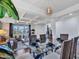 A dining room with coffered ceilings features a glass table and ample natural light from the large windows at 16322 N 171St Dr, Surprise, AZ 85388