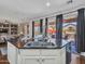 Kitchen island with granite countertop, stainless steel sink, and backyard views at 16322 N 171St Dr, Surprise, AZ 85388