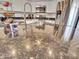 Close-up of a granite kitchen counter featuring white cabinets, stainless steel appliances, and a stainless steel sink at 16322 N 171St Dr, Surprise, AZ 85388