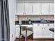 Cozy kitchen nook with a built-in desk, drawers and stylish dark granite countertops at 16322 N 171St Dr, Surprise, AZ 85388