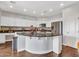 Spacious kitchen with white cabinets, granite countertops, stainless steel appliances, and wood-look tile floors at 16322 N 171St Dr, Surprise, AZ 85388