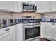 Close-up of the modern stainless steel gas range and oven in a bright, updated kitchen at 16322 N 171St Dr, Surprise, AZ 85388