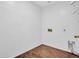 Functional laundry room with wood-look tile flooring and ample space for appliances at 16322 N 171St Dr, Surprise, AZ 85388