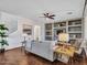 Open living room with hardwood floors, neutral decor, built-in shelving, and a staircase at 16322 N 171St Dr, Surprise, AZ 85388