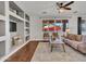 Stylish living room with decorative shelving, plush furniture, area rug, and backyard views at 16322 N 171St Dr, Surprise, AZ 85388