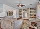 Bright living room with hardwood floors, plush sofas, custom shelving, and a cozy ambiance at 16322 N 171St Dr, Surprise, AZ 85388