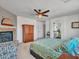 Main bedroom with stone fireplace, ceiling fan and an attached main bathroom at 16322 N 171St Dr, Surprise, AZ 85388