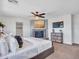 The main bedroom boasts a ceiling fan, fireplace, carpet flooring and a large window at 16322 N 171St Dr, Surprise, AZ 85388