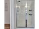 Modern bathroom with a glass-enclosed shower featuring a built-in seat and sleek chrome fixtures at 16322 N 171St Dr, Surprise, AZ 85388