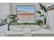 This main bathroom soaking tub features a view through the large window and decorative plants at 16322 N 171St Dr, Surprise, AZ 85388