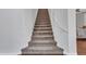 A carpeted staircase with a white handrail leads upstairs, showcasing the home's multi-level layout at 16322 N 171St Dr, Surprise, AZ 85388