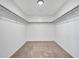The walk-in closet features carpet flooring, white walls, shelving and clothing racks at 16322 N 171St Dr, Surprise, AZ 85388