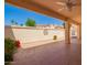 Covered back patio with a ceiling fan offers a relaxing space with views of the desert landscape at 1700 E Lakeside Dr # 64, Gilbert, AZ 85234