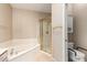 Bathroom featuring a garden tub, shower and toilet in a separate room, with a cabinet for storage at 1700 E Lakeside Dr # 64, Gilbert, AZ 85234